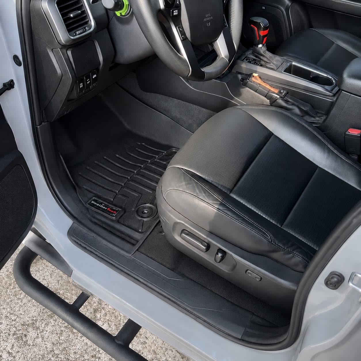 Truck interior after detailing with spotless floor mat, clean trim, and conditioned leather