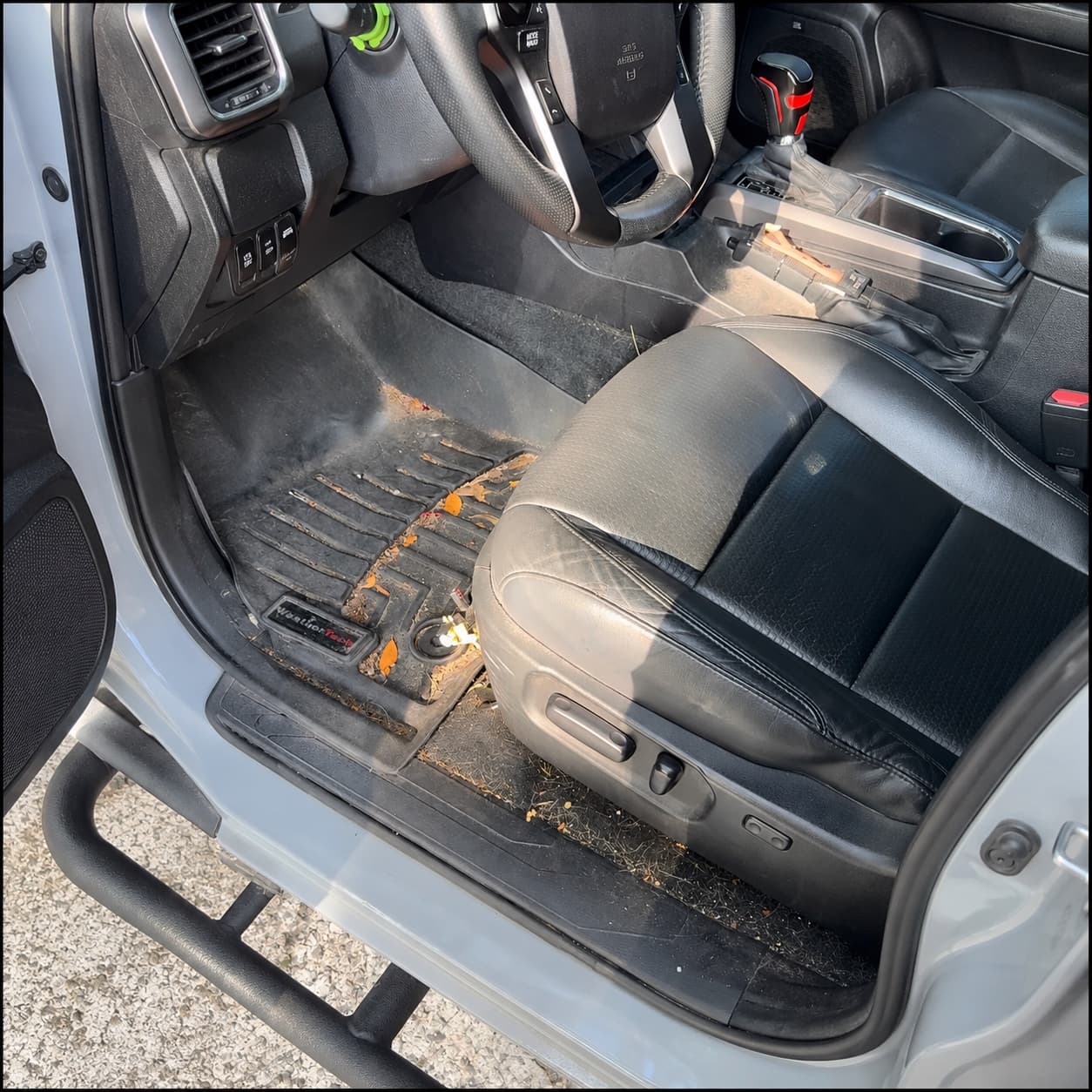 Truck interior before detailing with dirt, debris, and dusty trim