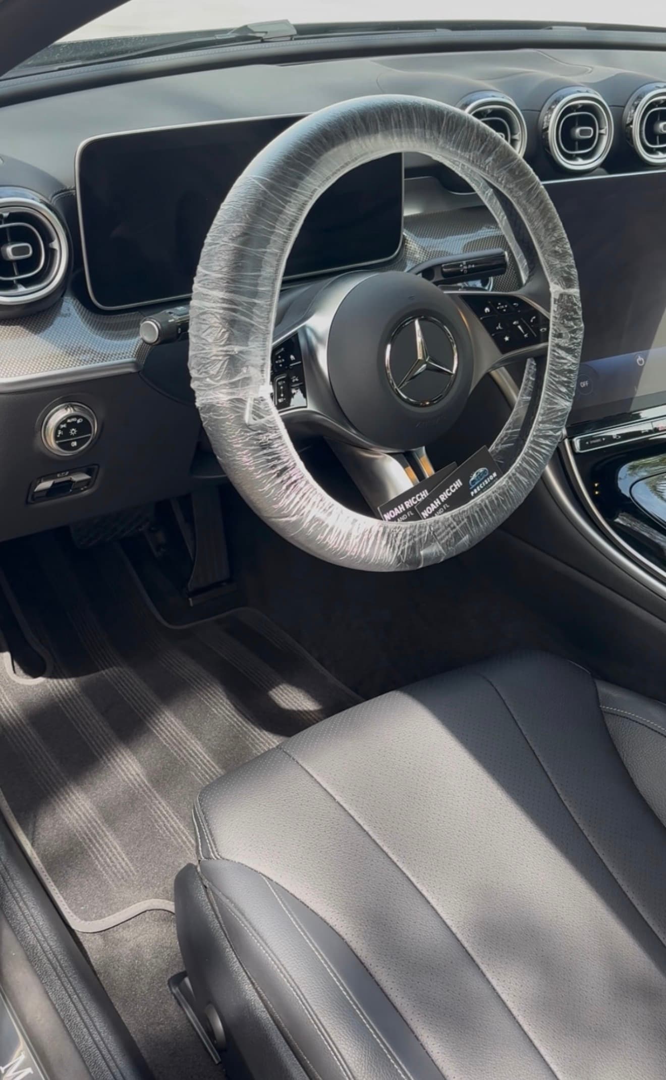 Mercedes interior detailed with clean black trim and protected steering wheel